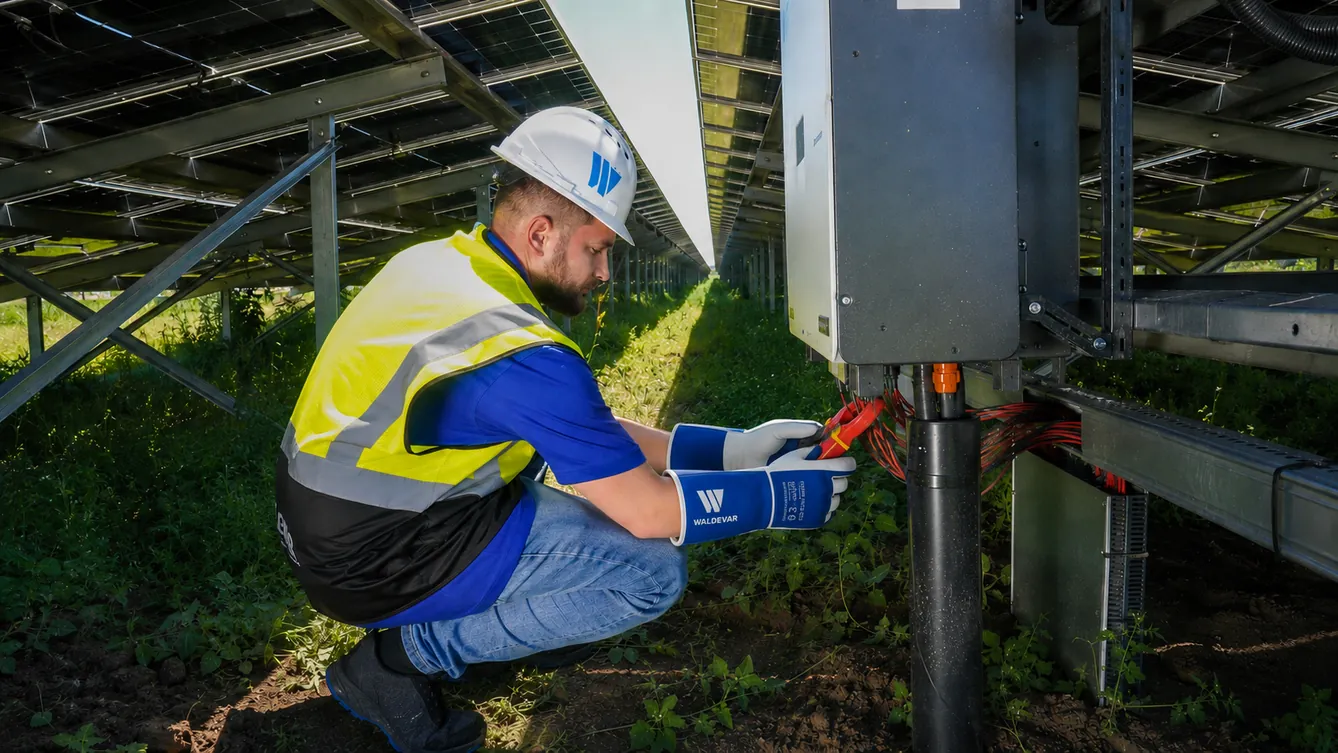 Technician running an I-V curve trace on a PV string